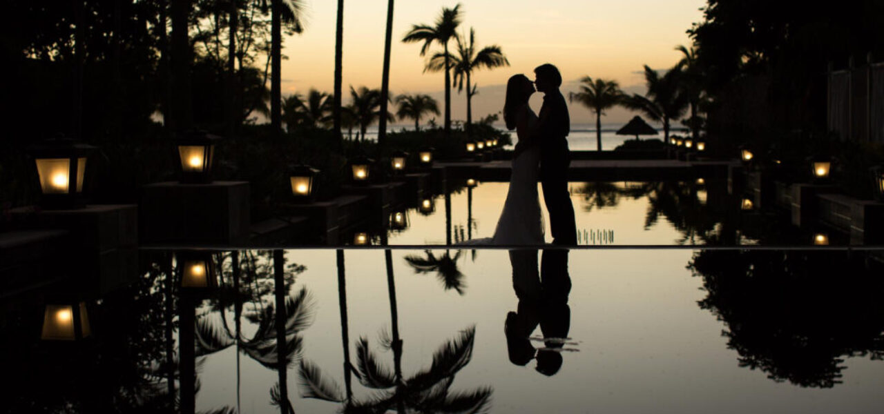 silhouettes-of-the-bride-and-groom-at-sunset-the-reflection-in-the-pool